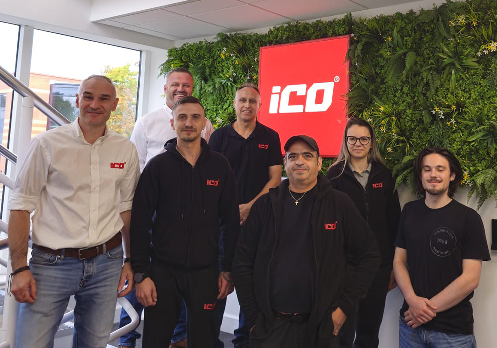 iCO Products team standing at the entrance of the new manufacturing and R&D facility