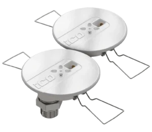 Pair of round white recessed ceiling light housings with metal spring clips used for mounting